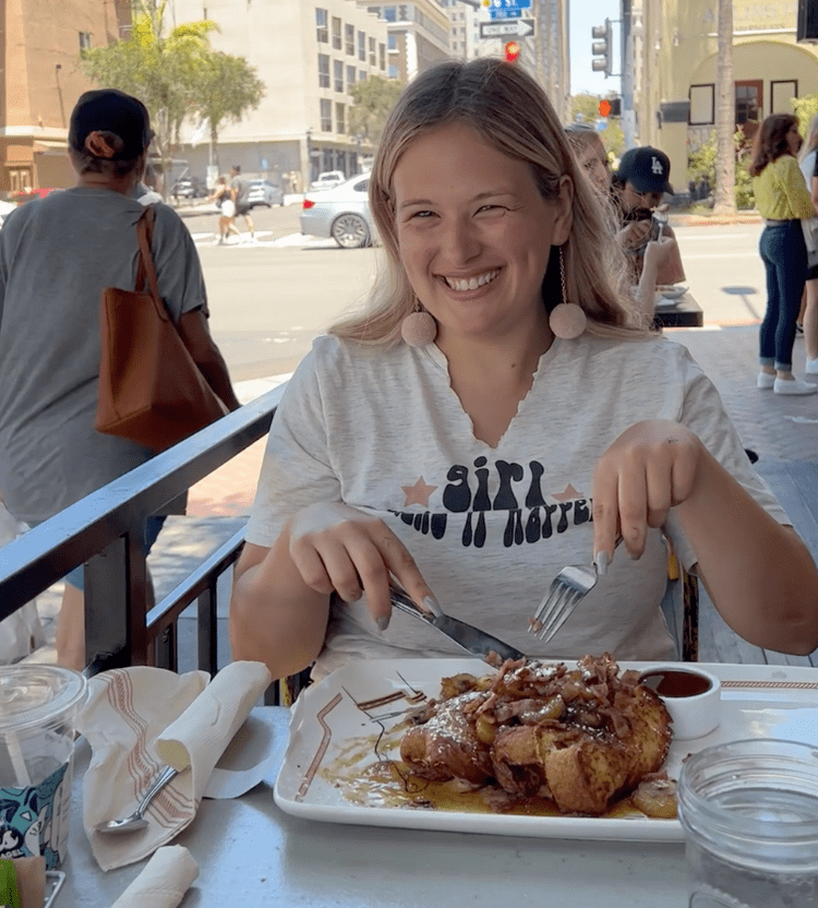 Rachael eating the peanut butter stuffed french toast from Breakfast Republic in Downtown San Diego