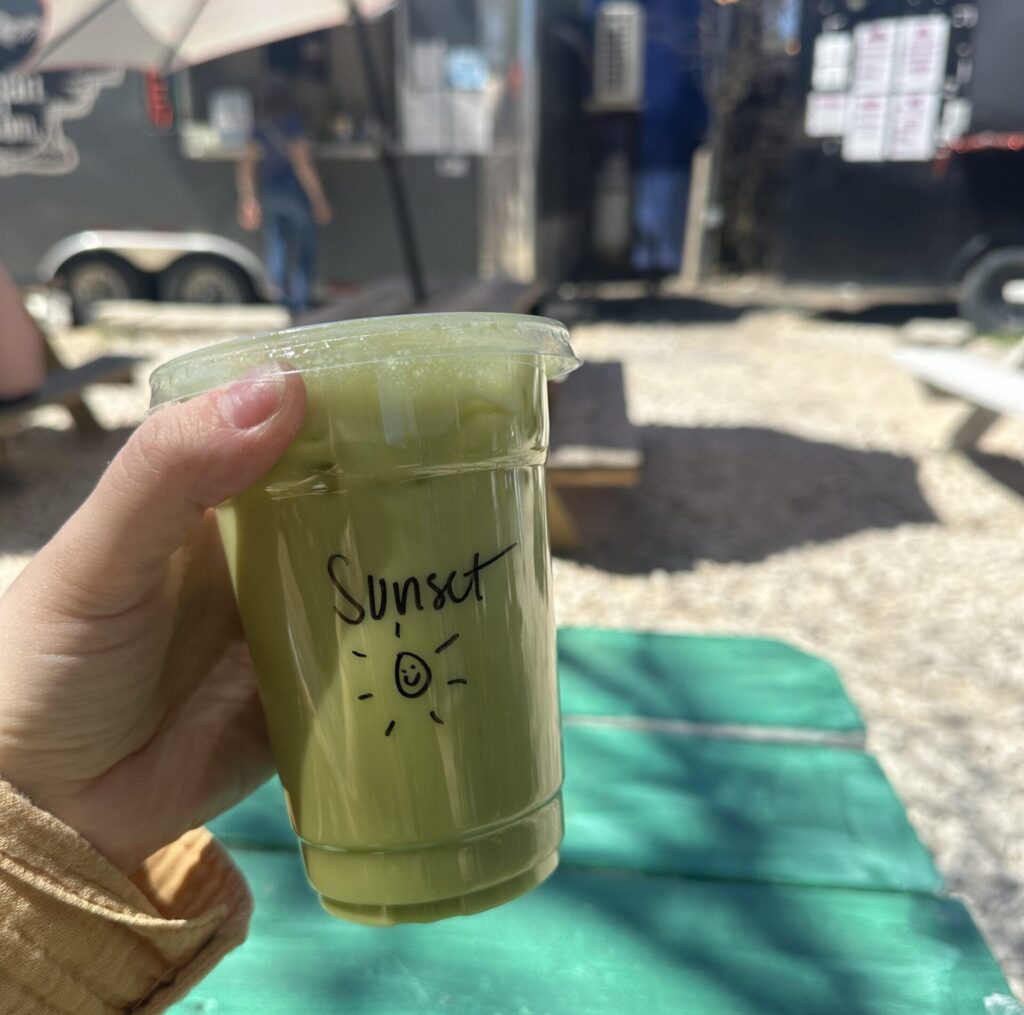 Person holding up matcha drink from Ghoul Coffee in Austin Texas
