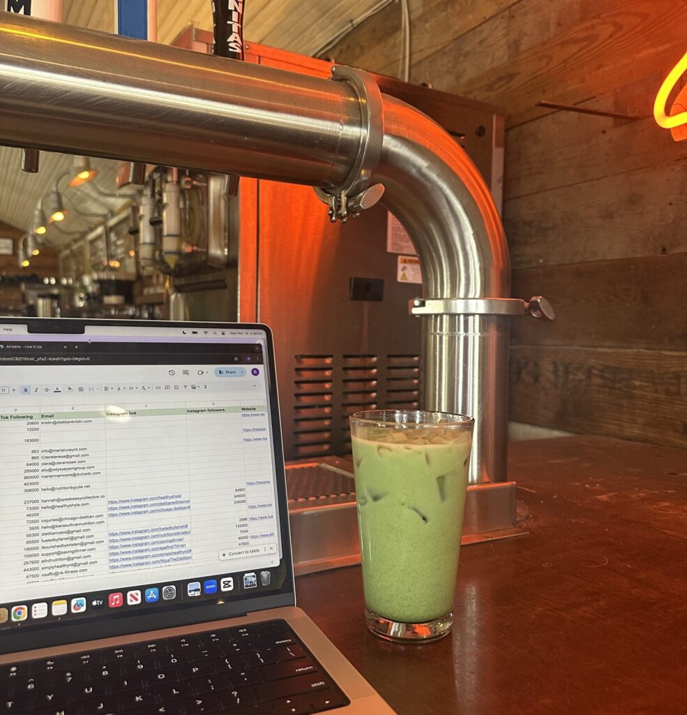 Glass of iced matcha next to a laptop on the bar at Radio Coffee in Austin Texas