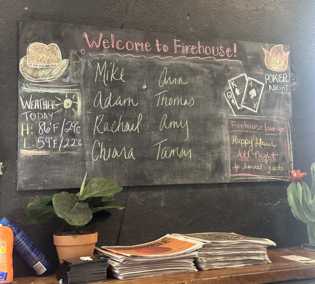 Chalkboard with names of new guests and other information at the Firehouse Hostel